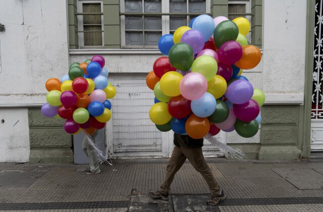Protesters carry balloons in a march on International Workers' Day in Santiago, Chile, on Wednesday, May 1, 2024.  (AP Photo/Matias Basualdo)